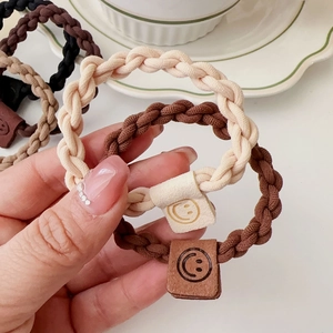 Elastic braided hair ties in earth tones with a cute smiley face square charm