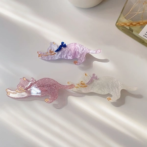 Detailed view of three cute cat hair clips with marble patterns and glitter resin finishes
