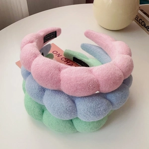 Close-up of pastel sponges headband set with woven Hand Made label detail