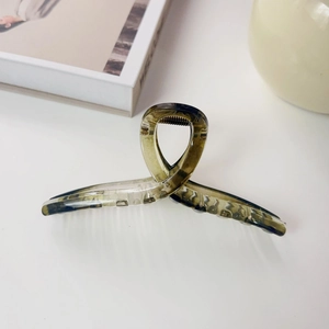 Detail of tortoise shell claw clip with glossy finish and crossover spiral design