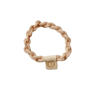 Elastic braided hair tie in beige pink featuring a classic smiley face decorative tag