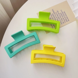 Three large matte rectangular hair claws in vibrant green, mint, and yellow colors