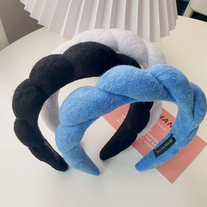 Detailed texture of handmade braided velvet sponge headbands in black, white and blue