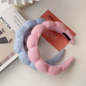 Thick plush twist sponge headband in light pink and blue with high top design
