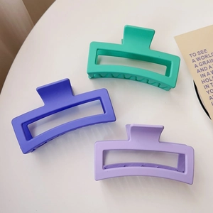 Three large matte rectangular shark hair claws in mint green, dark purple, and lavender hues