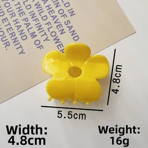 Detail shot of yellow flower hair claw clip showing 5.5cm diameter size and dimensions