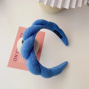 Detail of Klein blue padded braided headband with soft texture and hand made label