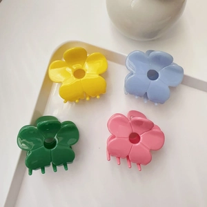 Floral acetate hair claws in four colors displayed on a white decorative tray