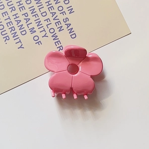 Detailed top view of a sweet pink acetate flower hair claw clip with glossy finish