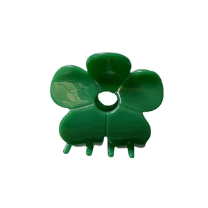 Vibrant green acetate flower hair claw clip with minimalist five-petal design on white background