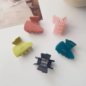 Detailed close-up of colorful matte jelly hair clips with French gold lettering