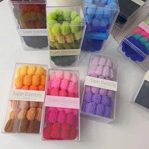 Nahaufnahme bunter elastischer Haargummis in transparenter Box mit OOTD Etikettierung