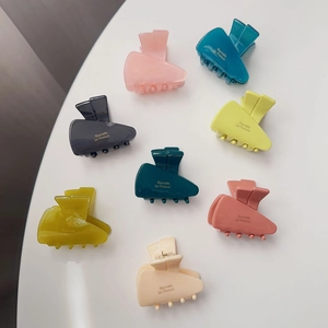 Set of eight colorful acetate carrot hair clips with golden Barrette La France lettering