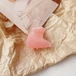 Close-up of a pink translucent mini hair claw clip with Barrette La France text