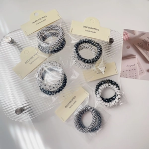 Detail of black and white spiral hair ties with checkered and polka dot patterns