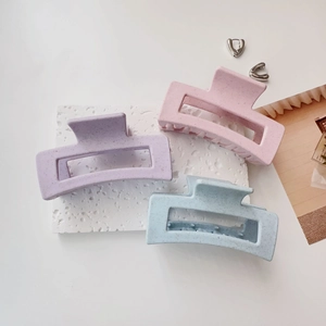 Three large matte macaron claw clips in lavender, pink and blue with speckled texture