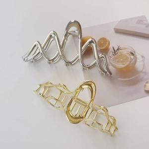 Set of large gold and silver wavy metal shark hair clips for thick hair styling