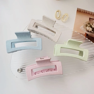 Set of four large matte pastel hair claws in pink blue cream and green tones