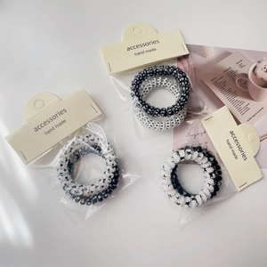 Detailed view of black and white spiral hair ties with star and heart patterns