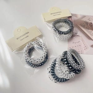 Set of black and white spiral telephone wire hair ties with heart and star patterns
