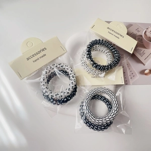 Set of 6 black and white spiral hair ties with heart and polka dot patterns for women