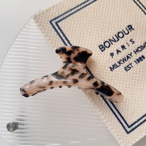 Detail of tortoiseshell acetate hair claw with handmade to France engraving on inner side