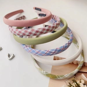 Detail of cream plaid headband collection featuring handmade interior labels for high quality