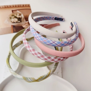 Close-up of handmade cream plaid headband set with soft fabric texture and inner woven label