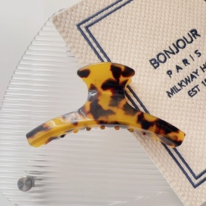 Detail showing the tortoiseshell pattern and texture of the large acetate hair claw clip