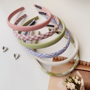 Detailed top view of handmade tweed plaid hairbands in multiple colors with heart earrings