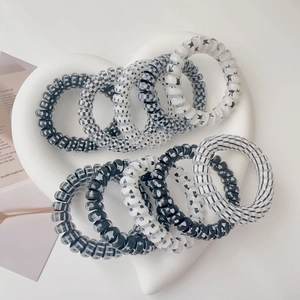 Set of 10 spiral telephone wire hair ties with checkers, dots, and hearts in black and white