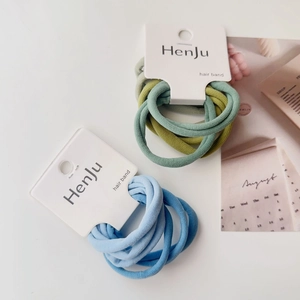 Detail of high-elasticity hair scrunchie sets in blue and green tones with Henju tags