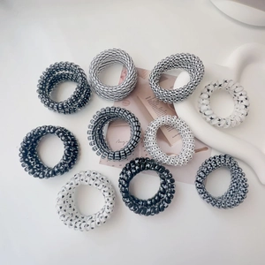10-piece black and white spiral hair ties set with various patterns on a minimalist background