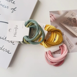 Close-up of high-elastic knit hair bands in Morandi tones on a white cardboard display