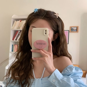Elegant metal bow hair claw clip for women styled with light blue puff sleeve top