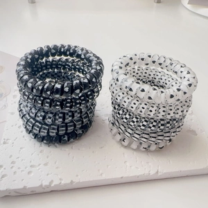 Close-up of spiral phone cord hair ties with heart and checkerboard patterns