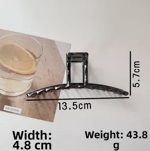 Detail view of large dark grey alloy hair claw clip with size measurements 13.5cm