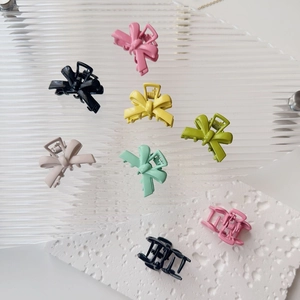 Collection of matte macaron metal bow hair clips for women in assorted pastel colors