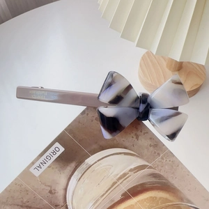 Detail of grey marble acetate bow hair clip showing France Handmade engraving on back