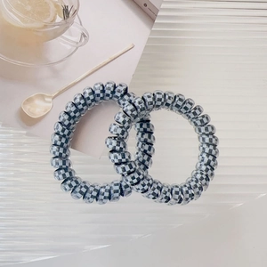 Detailed macro view of spiral hair ties featuring classic black and white checkerboard pattern