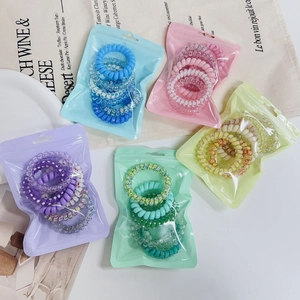 Pastel gradient spiral hair ties set in five color-themed matte zip bags