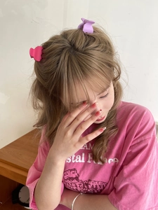 Matte candy-colored mini hair claw clips for high ponytail styling on model