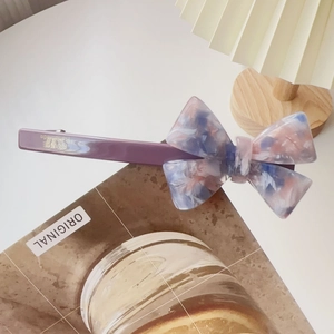 Detailed macro shot of the marbled acetate bow and France handmade engraving on the clip