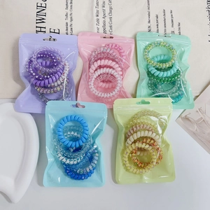 Close-up of candy color gradient spiral telephone wire hair ties in frosted packaging