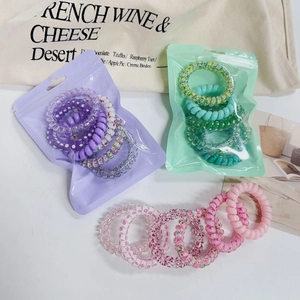 Colorful gradient spiral hair ties set with stars and polka dots in stylish packaging