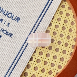 Détail d'une perle rose gelée avec motif à carreaux dorés sur une pince à cheveux