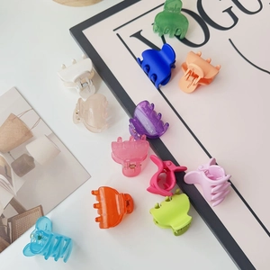 Close-up of 12-piece colorful candy-toned matte mini hair claws on a stylish background