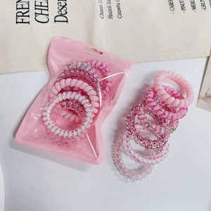 Close-up of pink spiral hair ties in solid colors and floral patterns in a soft set
