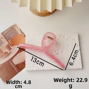 Detail view of large pink translucent hair claw clip with dimensions and weight data