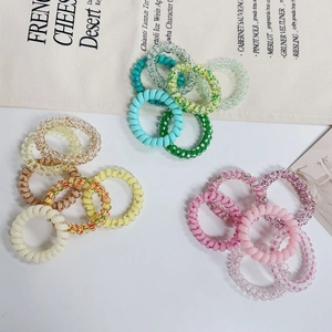 Close-up of colorful gradient spiral hair ties in various pastel shades and patterns